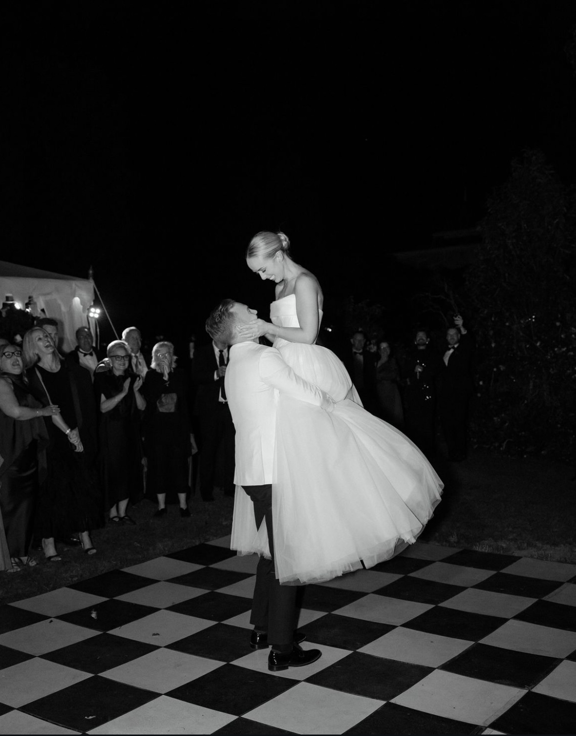 Nick lifting Georgia during their elegant first dance at their wedding.