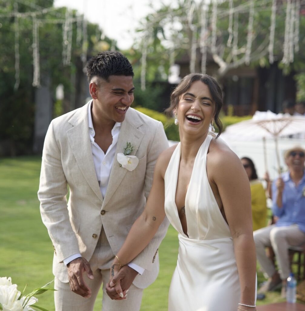 Jess and Ameer laughing on their wedding day