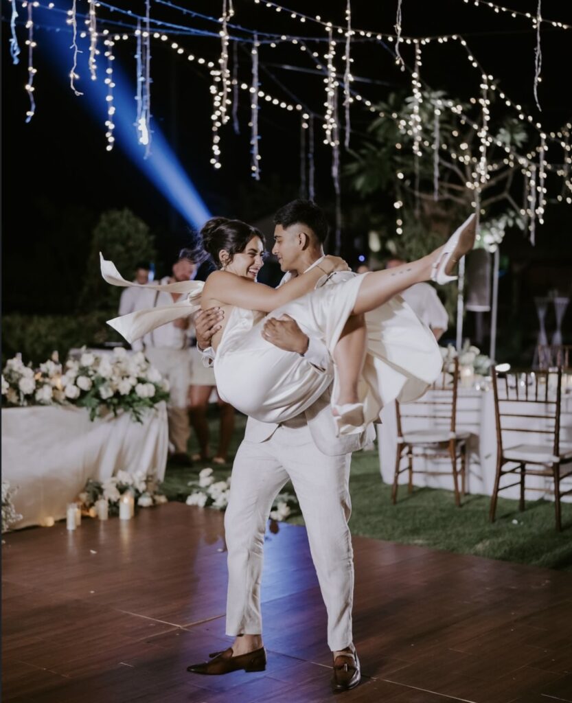 Ameer lifts Jess during their first dance.