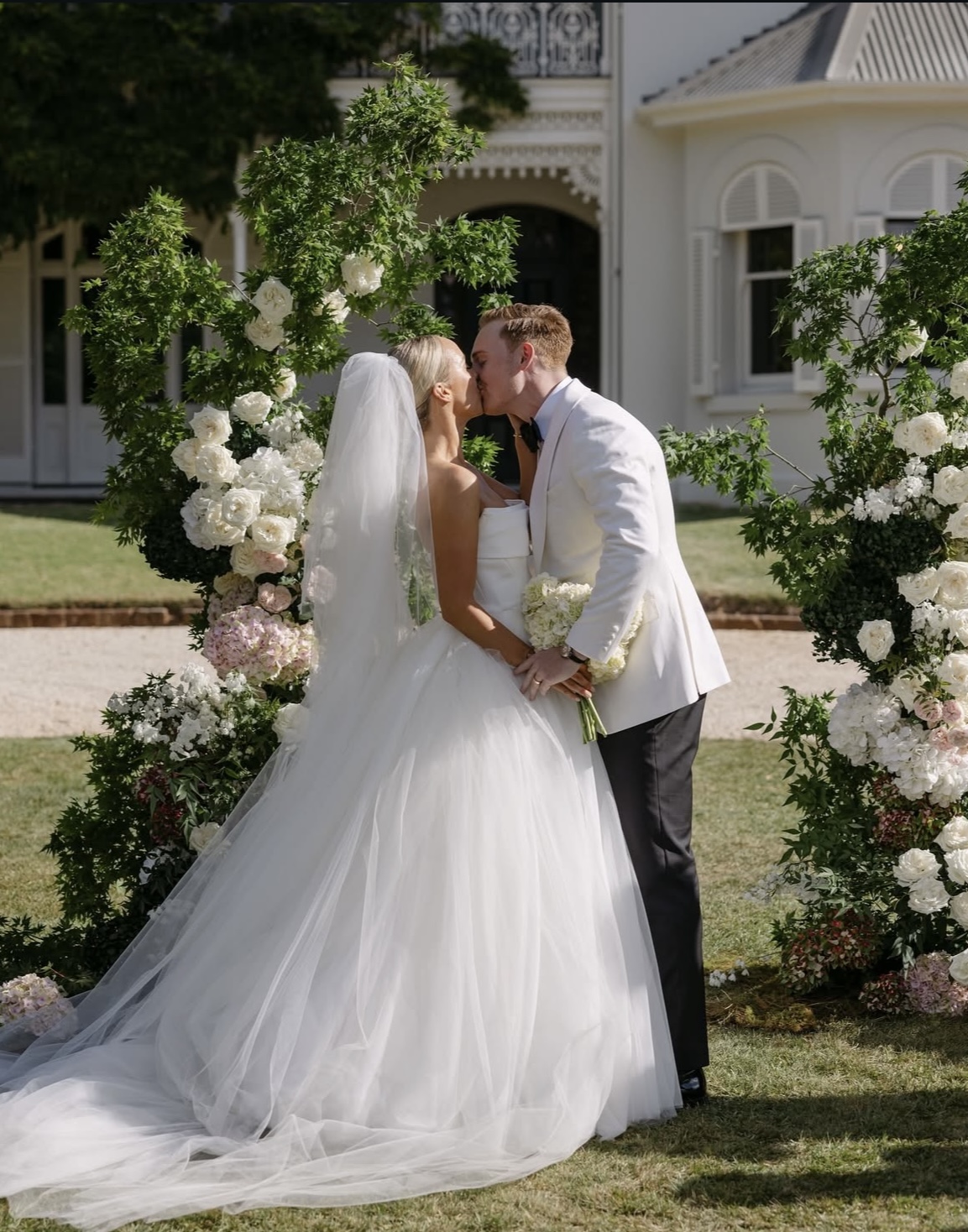 Georgia and Nick sharing a kiss right after their wedding ceremony.