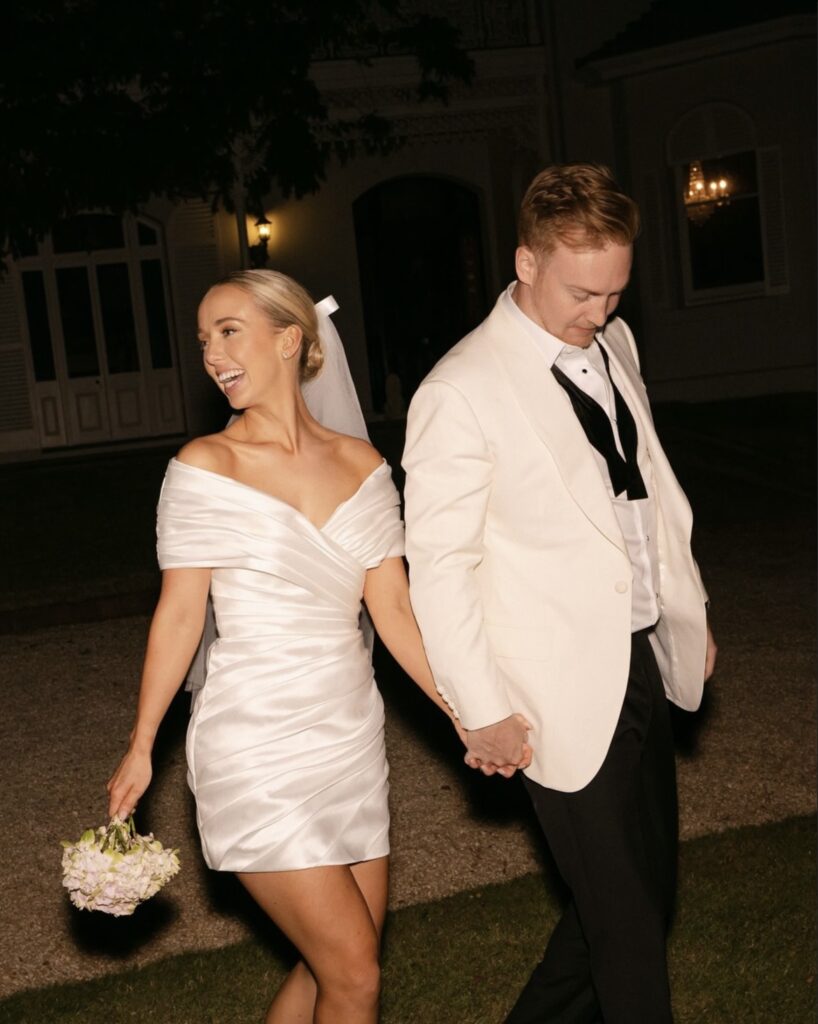 Georgia and Nick dressed in their evening party wear at their wedding celebration.