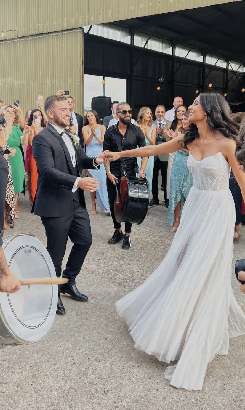 Couple performing their heartfelt first dance at their wedding, embodying the joy and unique connection of their love story.